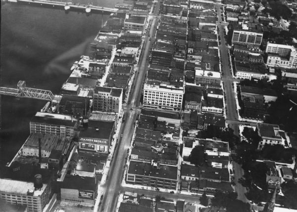 Aerial view of Green Bay's commercial district, bridges, and water.