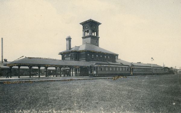 Chicago and North Western Railroad depot, train, and tracks.