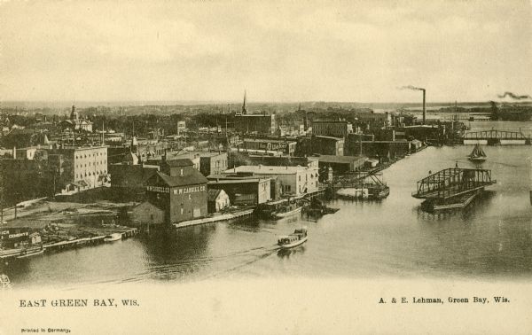 Elevated view of east Green Bay harbor with cargo ships, W.W. Cagill Co., and other various industries.