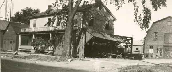 "Miss Mahan's School" with a tree in front and a farmhouse next door.