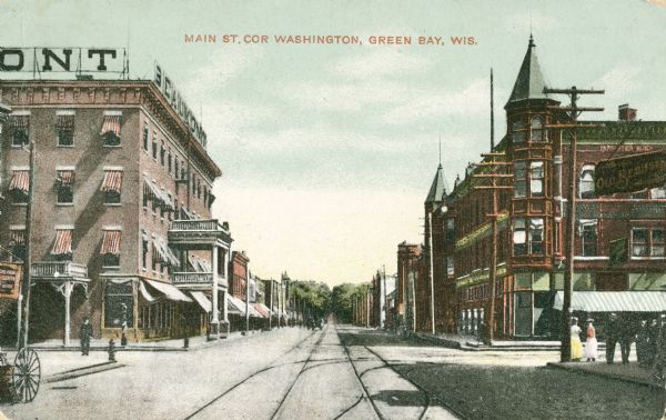 Main Street on the corner of Washington Street shops. Caption reads: "Main St, Cor Washington, Green Bay, Wis."