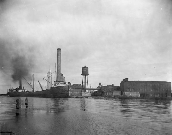 Chimney and water towers at Northern Paper Mills, also a cargo ship called the Yorkton, which carries lumber to the paper mill.