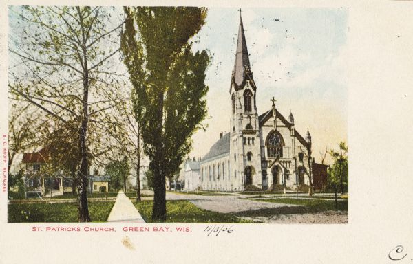 View down sidewalk, with St. Patrick's Church across the street on the right. Caption reads: "St. Patrick's Church, Green Bay, Wis."