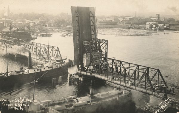 Elevated view of cargo ship passing under the Walnut Street Bridge on the Fox River.