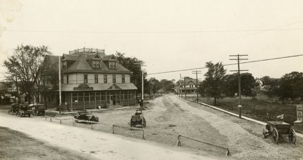 Elevated view of intersection of the Janesville Plank Road and North Cape Road at Hales Corners, also showing Schubrino's Saloon. The Janesville road, sometimes known as the Milwaukee-Janesville Plank Road, dates to 1849, and it was for many years a major route for the transport of agricultural products to Milwaukee. Both roads still exist, although the Janesville Road, now a major divided highway, no longer includes a reference to its origins as a plank road in its name. Even in 1917, when this photograph was taken, no evidence of its history as a plank road was apparent.