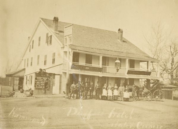 The Western Hotel. The original tavern was built in 1834 (?) by William Shields (?). In 1845 it was operated by his son Simon Shields. In 1873 the Hotel was taken over by Joseph Dreyfuss and was subsequently known as Hotel Dreyfuss. Presented in 1913 by the current proprietor Julius Dreyfuss, son of Joseph Dreyfuss. A group of men and women are posing in front of the hotel. Signs on the front of the hotel read: "F. Falks Lager Beer" and "J. Dreyfuss".