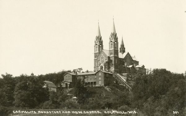 View looking up at Holy Hill. Caption reads: "Carmelite Monastery and New Church, Holy Hill, Wis."