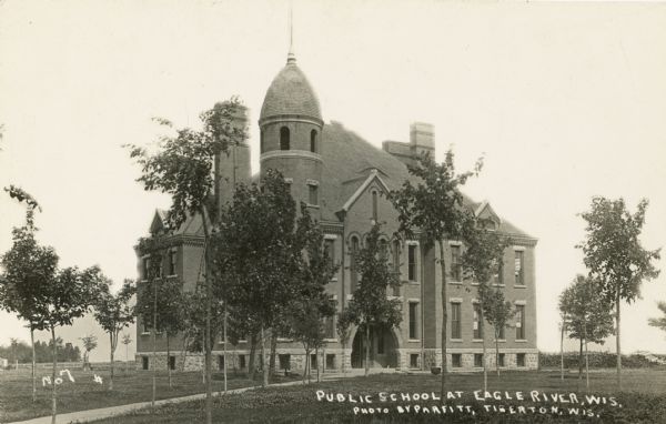 Exterior of the public school. Caption reads: "Public School at Eagle River, Wis."