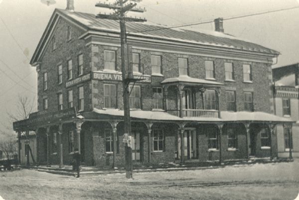 View of the exterior of the Buena Vista House, a hotel located in East Troy. This Greek revival inn was erected in 1843 by Samuel R Bradley of Milwaukee, who is said to have gathered personally all of the cobblestones used in its construction. He and his wife managed the inn from its opening in the late 1840s until about 1851.