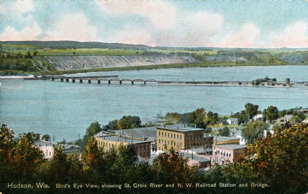 Elevated view of the St. Croix River, Northwest Railroad, bridge, and part of the town of Hudson. Caption reads: "Hudson, Wis. Bird's Eye View, showing St. Croix River and N. W. Railroad Station and Bridge."