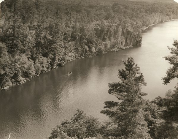 Elevated view of a canoe on the St. Croix River with wooded areas on both sides within the Interstate State Park.  Established in 1900, Interstate Park was the first of Wisconsin's state parks.  It was created on a cooperative basis with the state of Minnesota, which has jurisdiction over the portion of the park situated on the west bank of the St. Croix River.