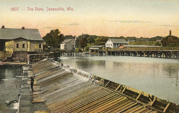 View across the dam in Janesville. Caption reads: "The Dam, Janesville, Wis."