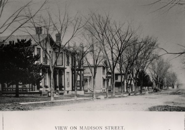 View down Madison Street with houses along sidewalk. Caption reads: "View on Madison Street."