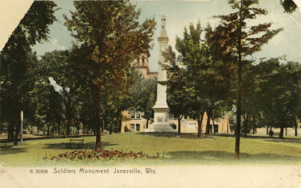View across lawn towards the Monument. A building is in the background. Caption reads: "Soldiers Monument, Janesville, Wis."