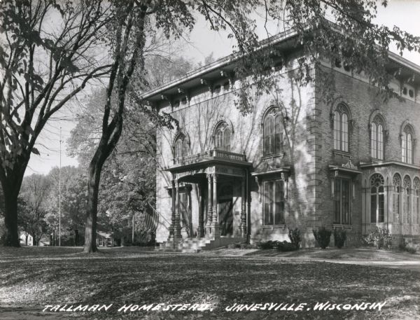 View across lawn towards the front and right side of the Tallman House. Caption reads: "Tallman Homestead, Janesville, Wisconsin".