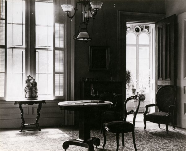 Interior view of a corner of the parlor and the open doorway to the conservatory.
