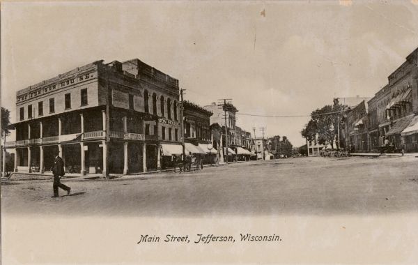 View down Main Street. On the left corner is the Jefferson House. Caption reads: "Main Street, Jefferson, Wisconsin."