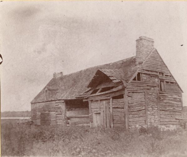 The home and fur-trading post of Col. Dominique DuCharme. The portion of the structure on the left was built by DuCharme in 1791. The right portion was added by Augustin Grignon after he acquired the property in 1813. The building was razed around 1892.