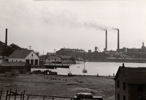 A view across Kenosha harbor at the large Simmons Company factory building.
