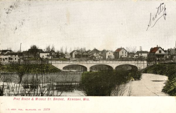 The Middle Street bridge over the Pike River. Caption reads: "Pike River & Middle St. Bridge, Kenosha, Wis."