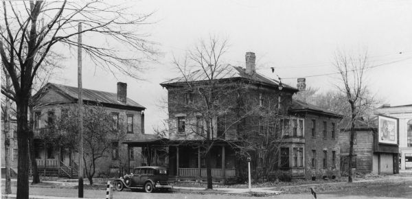 Tenth and Fifty-seventh Streets, with early houses, car and barn.