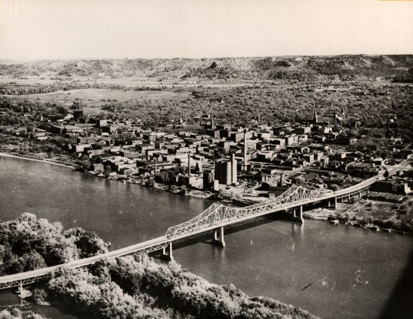 Aerial view of La Crosse and the Mississippi River. In the foreground is the new bridge as of 1953.