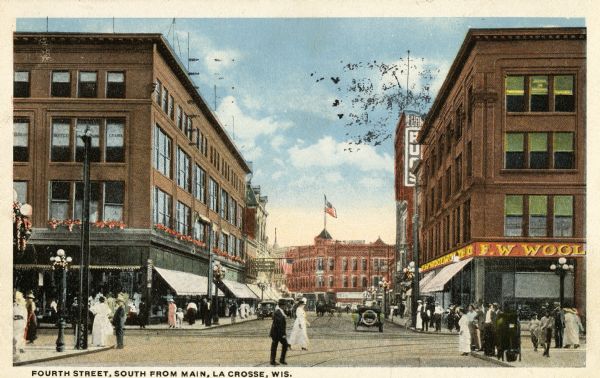 View toward intersection. There are many pedestrians on the sidewalks and in the street. Caption reads: "Fourth Street, South from Main, La Crosse, Wis."