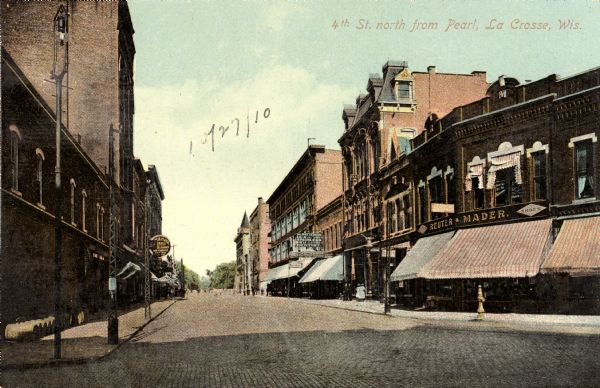 View down street with businesses on both sides. Caption reads: "4th St. north from Pearl, La Crosse, Wis."