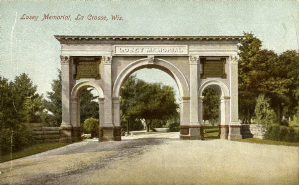 The Losey Memorial Arch, built in honor of Joseph W. Losey. Mr. Losey was an early pioneer lawyer of the town, made District Attorney in 1857 and City Attorney in 1860. He was extremely active in many phases of community life, and was especially interested in beautifying the city. He died in 1901. Caption reads: "Losey Memorial, La Crosse, Wis."