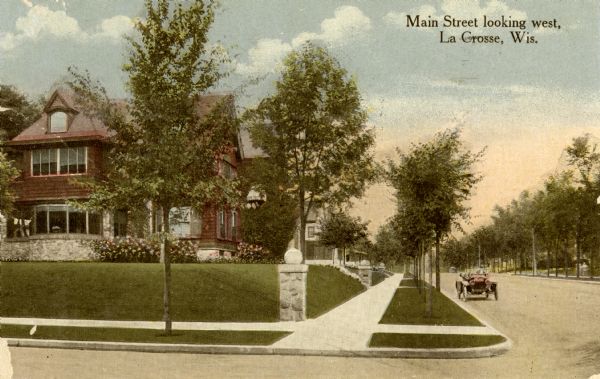 View across street looking west from 15th Street towards houses on the left side. Caption reads: "Main Street looking west, La Crosse, Wis."