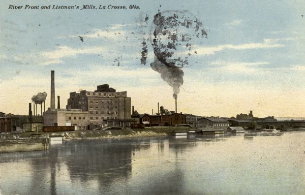 View across water toward the Mississippi River front showing Listman's Mills. Caption reads: "River Front and Listman's Mills, La Crosse, Wis."