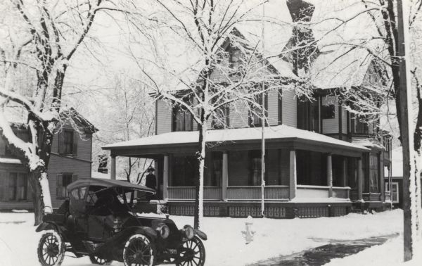 Exterior view of the Seven Gables Inn with a parked car in the foreground.