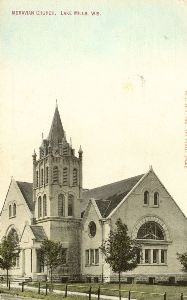 View across street towards the Moravian Church. Caption reads: "Moravian Church, Lake Mills, Wis."