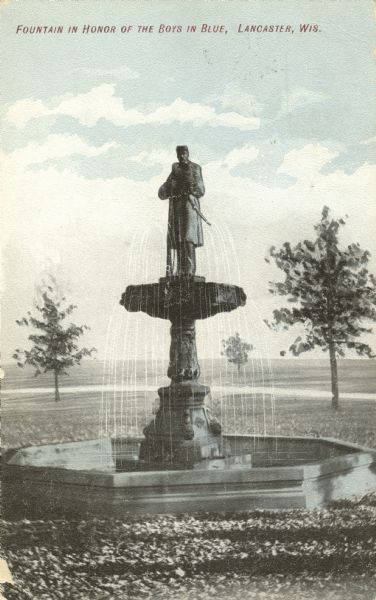 A Civil War Monument and fountain in Lancaster. Caption reads: "Fountain in Honor of the Boys in Blue, Lancaster, Wis."