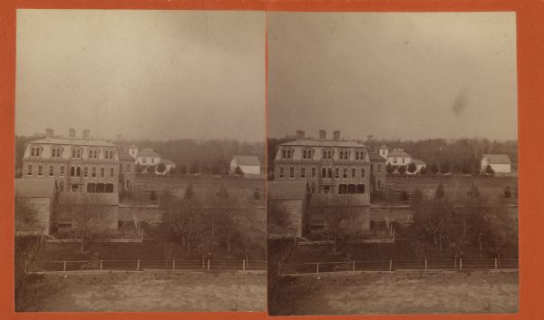 Stereograph view looking downhill towards the three-story Farwell Hotel in Lancaster.