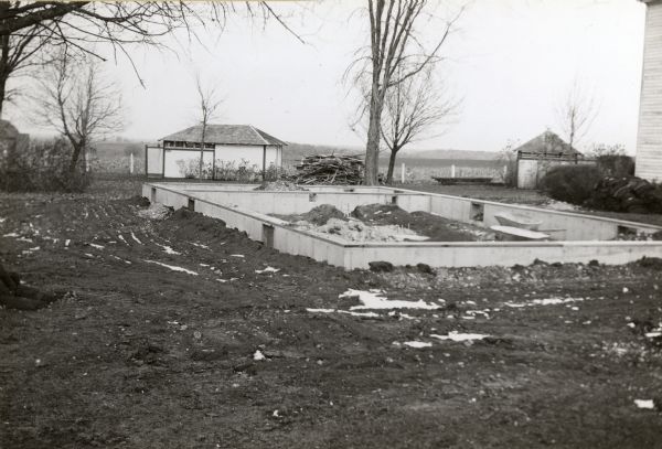 Foundation built for the lodging house at First Capitol Historic Site. The lodging house was moved and restored in the 1950s.  The corner of the Council House can be seen at the right.