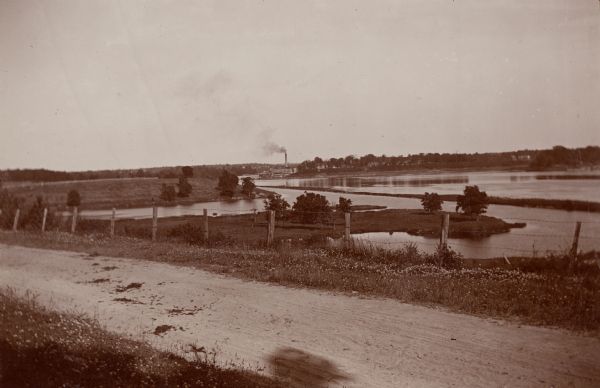 The Fox River seen from the hill behind the Catholic Church and looking toward the combined locks. In the distance is a paper mill.