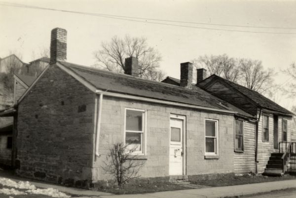 The home of a Cornish miner in Mineral Point. Houses are on a hill in the background.
