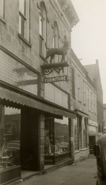 The Gundry, Gray and Company Furniture Store with a sculpture of a dog mounted on the store sign.