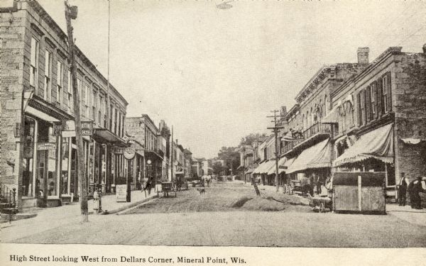 View down street, with storefronts on both sides. Caption reads: "High Street looking west from Dellars Corner, Mineral Point, Wis."