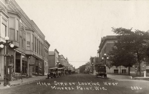 The businesses on High Street, with automobiles parked along the curb. Caption reads: "High Street  Looking West Mineral Point, Wis."