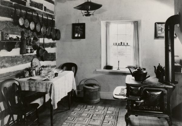 The kitchen in the restored Cornish miner's house, called Polperro, on Shake Rag Street. The house was temporarily covered with siding, but after restoration the siding was removed to reveal the original log construction. The building is currently owned by the Wisconsin Historical Society and is one of several structures that comprise the Pendarvis historic site.
