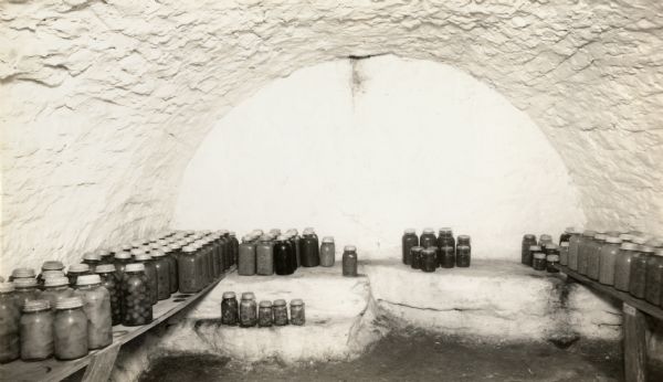 Jars of canned food are stored in the cellar of the restored Cornish miner's house, called Polperro, on Shake Rag Street. The house was temporarily covered with siding, but after restoration the siding was removed to reveal the original log construction. The building is currently owned by the Wisconsin Historical Society and is one of several structures that comprise the Pendarvis historic site.
