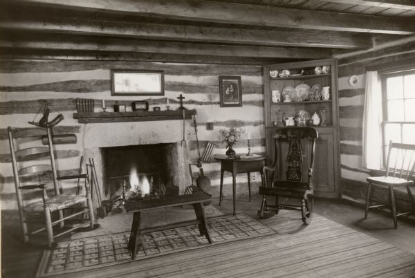 The living area in the restored Cornish miner's house, called Polperro, on Shake Rag Street. The house was temporarily covered with siding, but after restoration the siding was removed to reveal the original log construction. The building is currently owned by the Wisconsin Historical Society and is one of several structures that comprise the Pendarvis historic site.