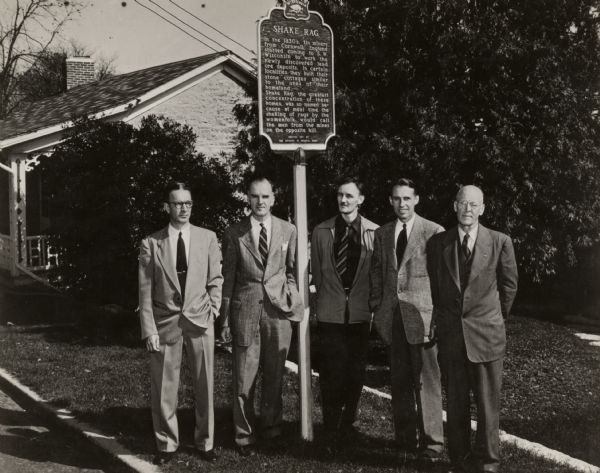 The official Wisconsin marker of Shake Rag Street and the committee of citizens who sponsored placing the marker. (Left to right): Ross Graves, President of Mineral Point Kiwanis Club; Robert M. Neal, Pendarvis House; Max Fernekes, President of Mineral Point Historical Society; Edgar G. Hellum, Pendarvis House; Dr. H.D. Ludden, Mayor of Mineral Point.