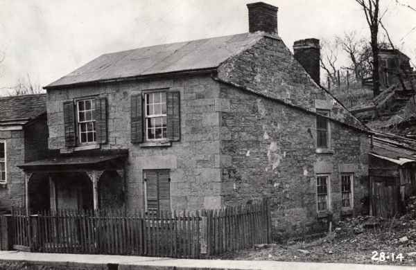 Exterior view of a Cornish miner's cottage on Shake Rag Street called Trelawny. The cottage was restored under the ownership of Robert M. Neal and is now used to serve Cornish meals to guests by special reservation.