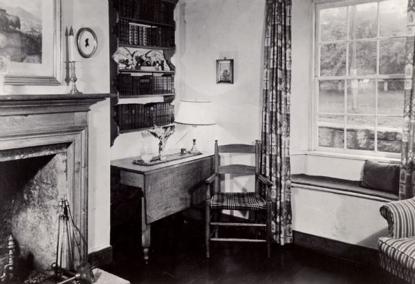 A corner desk and bookshelf in the Cornish miner's cottage on Shake Rag Street called Trelawny. The cottage was restored under the ownership of Robert M. Neal and is now used to serve Cornish meals to guests by special reservation.