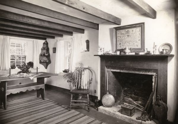 The living room fireplace and dining room table in the Cornish miner's cottage on Shake Rag Street called Trelawny. The cottage was restored under the ownership of Robert M. Neal and is now used to serve Cornish meals to guests by special reservation.