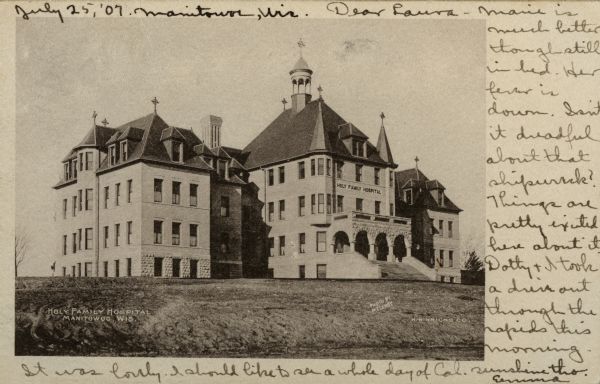 View across lawn toward the hospital. Caption reads: "Holy Family Hospital, Manitowoc, Wis."