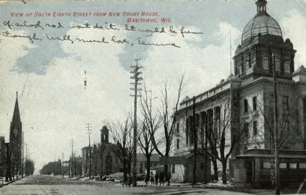 View up street with a large building on the corner on the right, and church buildings further down the street. Caption reads: "View up South Eigth Street from New Court House, Manitowoc, Wis."